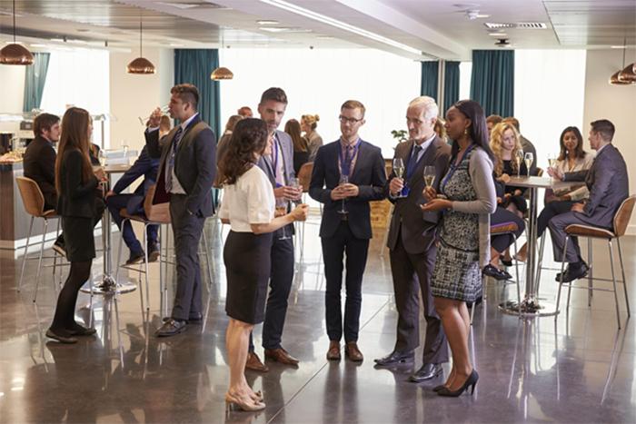 businesspeople standing around at a cocktail hour