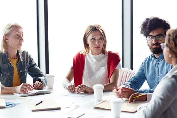 four people sitting around a table