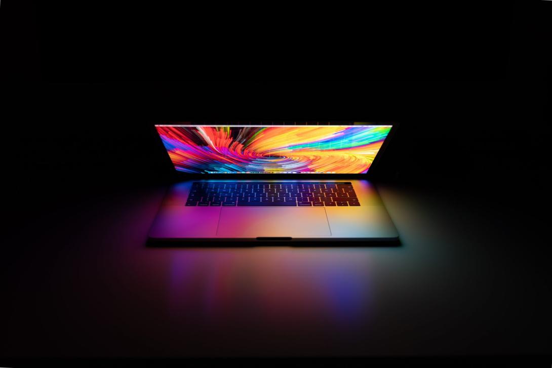 half-open laptop with psychedelic desktop background